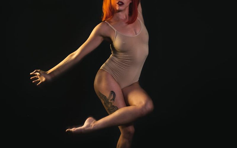 Silhouette of a person performing a controlled lunge movement.